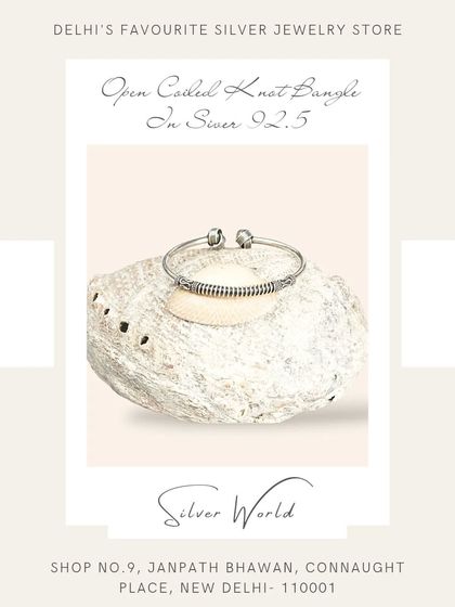 This open coiled knot bangle features antique-style detailing. It's a free-size design that adds a touch of rustic charm to your wrist.