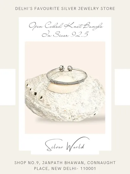 This open coiled knot bangle features antique-style detailing. It's a free-size design that adds a touch of rustic charm to your wrist.