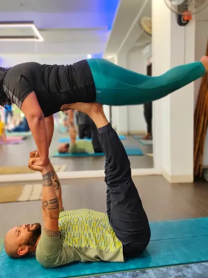 A variation of the "bird" pose in Acro Yoga, this demonstrates the strength of the base and the grace of the flyer.
