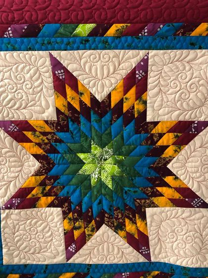 A close-up of the central star, showing the intricate piecing.