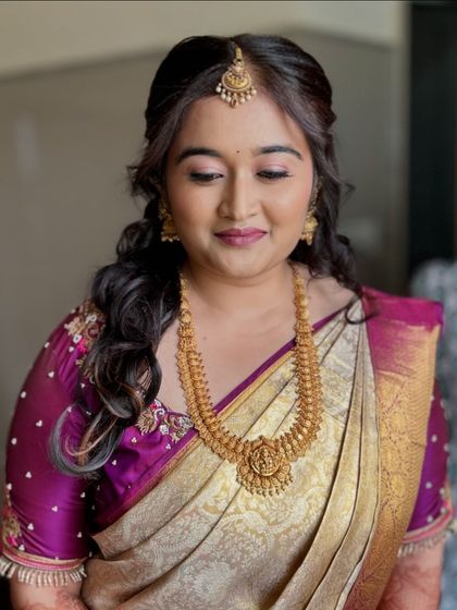 The soft, wavy hairstyle perfectly complements her traditional saree and the minimal makeup look for her engagement.
