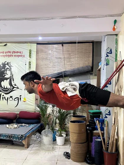 This side view of a student in a wall-rope-assisted pose shows the perfect spinal alignment we aim for. The ropes support the body's weight, allowing for a full extension from the heels to the crown of the head, which builds incredible core and back strength.