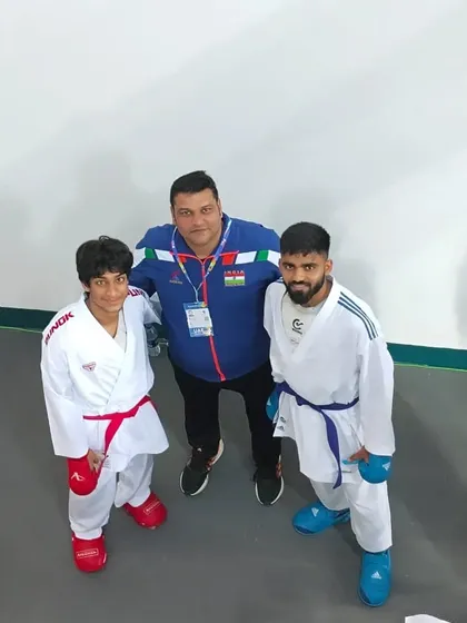 With two of my dedicated students. My goal is to be more than a coach; it is to be a mentor who inspires them to be their best, inside and outside the dojo.