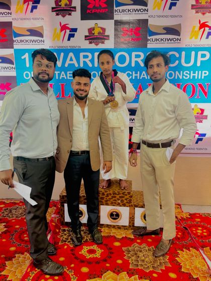 A proud moment for this young champion, standing on the podium with her medal. Her success is a result of her relentless effort and training.