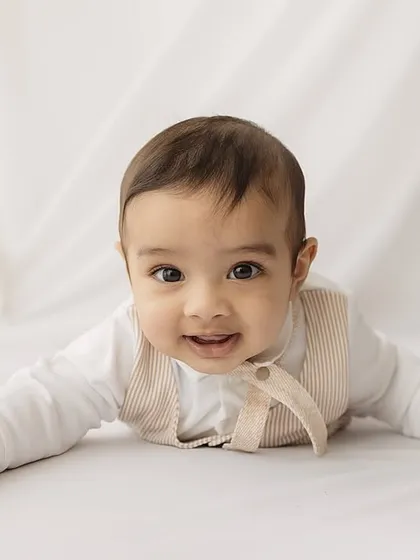 A sweet, direct-to-camera portrait of the 6-month-old.