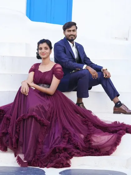 A beautiful pre-wedding photo at our Santorini-themed set. The bride's magnificent ruffled gown looks stunning against the clean white and blue architecture.
