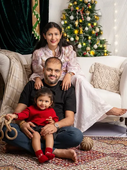 A perfect family moment, wrapped in the warm glow of Christmas lights. These are the pictures that become cherished holiday cards and timeless memories.