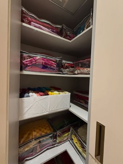 We make use of every corner. This L-shaped shelf is perfect for storing seasonal or heavy festive wear in protective, clear-front bags.