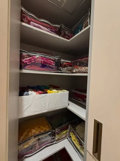 We make use of every corner. This L-shaped shelf is perfect for storing seasonal or heavy festive wear in protective, clear-front bags.