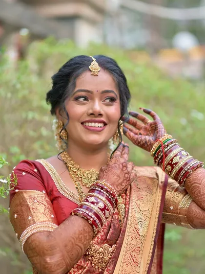 A candid and joyful portrait of the bride. Her happiness is evident, and she looks stunning in her traditional South Indian bridal attire.