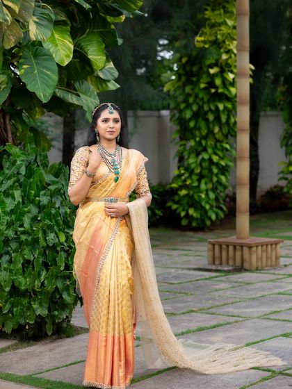 This look from my 'Athiloka Sundari' series features me in a pure Kanchi saree. I paired it with a blouse adorned with intricate embroidery and semi-precious stone embellishments, creating a regal outfit designed to make any bride feel like a princess.