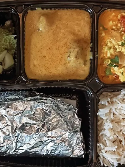 A unique thali featuring kadi pakoda and paneer bhurji. The tangy kadi and the savory paneer bhurji make for a very interesting and tasty combination.