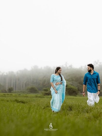 A walk through the lush green fields. The simplicity of the scene allows the couple's connection to be the main focus.