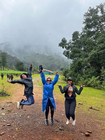 Jump for joy. Three friends mid-air, celebrating the fun of the Kodachadri trek.