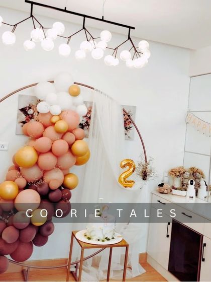 Celebrating a second birthday with a chic at-home setup. This design shows how we can transform any space with a stylish balloon arch in a warm, autumnal color palette and a modern circular backdrop.
