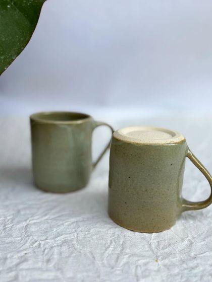 Two of our Green Celadon mugs. This is a classic, versatile glaze that looks great on any form.