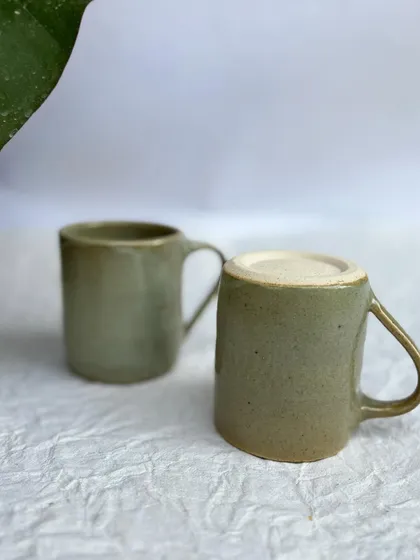 Two of our Green Celadon mugs. This is a classic, versatile glaze that looks great on any form.