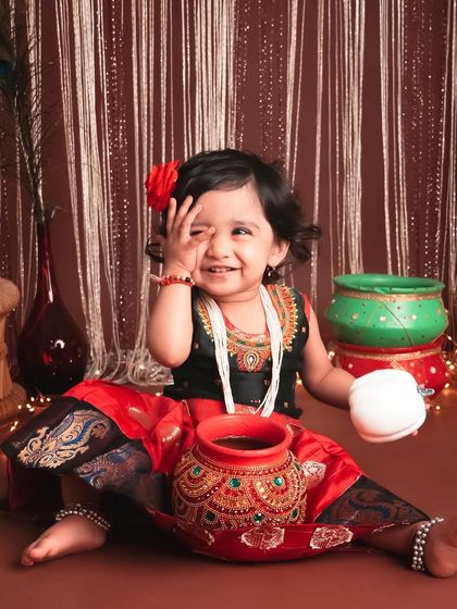 What a box full of expressions looks like! This little girl dressed in a traditional outfit for a festive theme is just so expressive and full of personality.