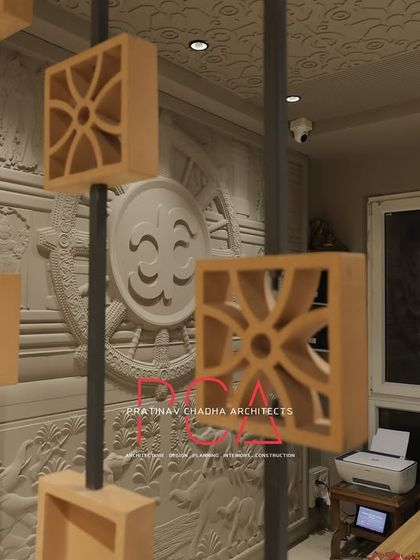 A detail shot showing the relationship between the wooden block screen and the large, carved mural in the background.