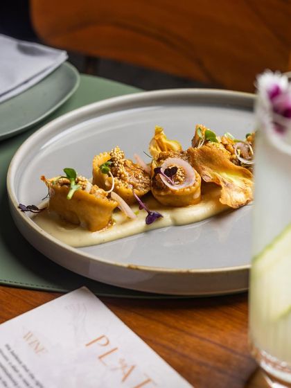 Our corn and ricotta tortellini served alongside a refreshing cocktail, illustrating the complete dining experience at Plats.