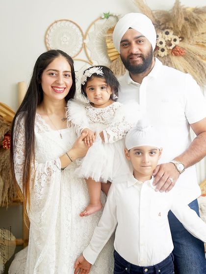 A lovely family of four dressed in all white. Their coordinated outfits create a clean, fresh, and timeless look in this beautiful boho-themed portrait.