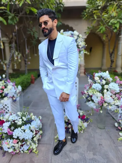A crisp, all-white suit, perfect for a daytime event or a white-themed party.