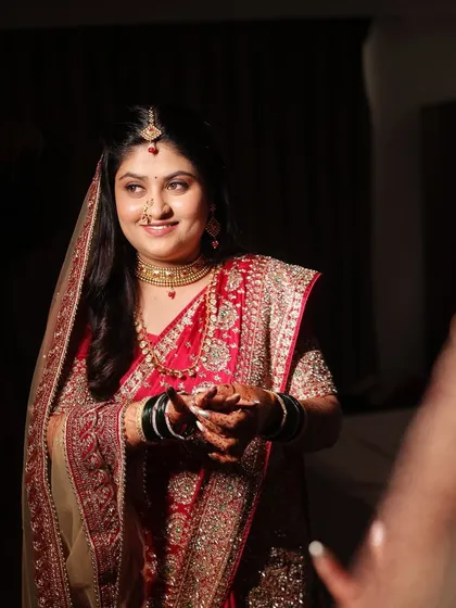A beautiful, candid moment. The makeup is designed to look natural and radiant, capturing her happiness perfectly.