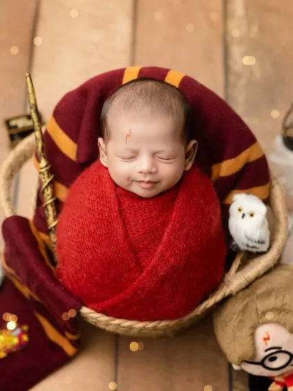 Expecto Patronum! A magical Harry Potter themed shoot for a newborn wizard, complete with a wand, Hedwig, and a Gryffindor scarf.