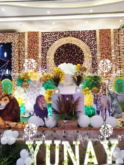 For a truly grand and luxurious celebration, I create immersive jungle and safari themes. This opulent stage design features a backdrop of rich floral panels, life-sized 3D animal props, and dramatic lighting to bring the wild to life in the most spectacular way.
