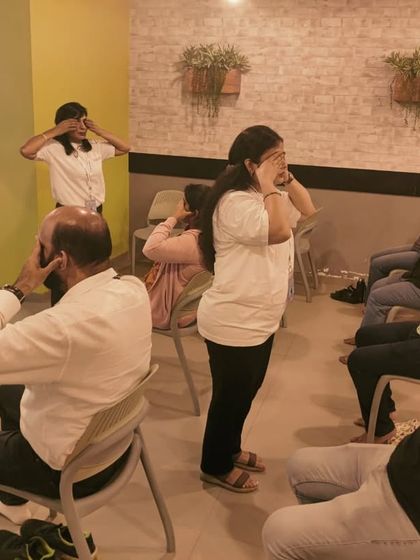 Employees at Connekt in Thane West practicing Bhramari Pranayama (Humming Bee Breath). This is a powerful technique to quickly de-stress and quiet the mind, even in a busy office environment.