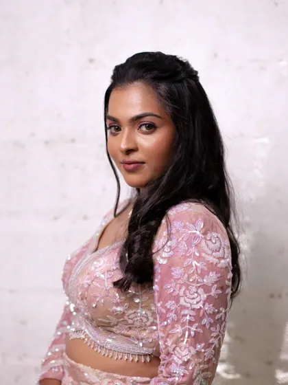 The art of subtle glam. This look from a model shoot features a beautiful pink lehenga and soft, natural makeup that enhances her features without being overpowering.