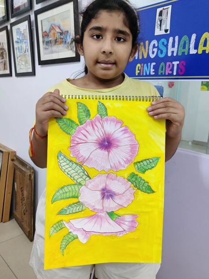 A young student carefully paints a floral composition, learning to control the water and pigment to create soft, blended colors.
