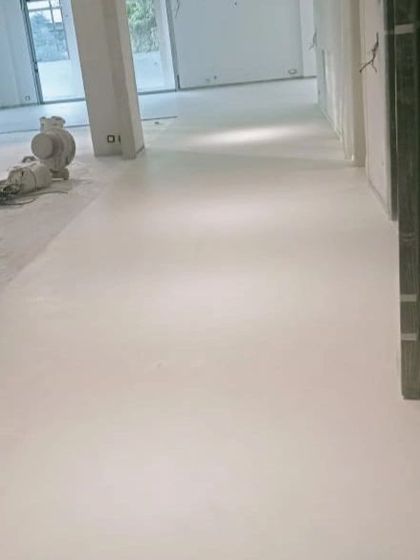 Another shot of the freshly laid microconcrete floor, showing its clean and continuous finish. This material is one of our favorites for creating modern, uncluttered spaces.