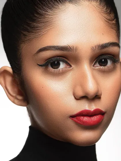 This tight close-up creates an intimate and powerful headshot. By filling the frame with the model's face, the focus is entirely on her expression and the details of her features, making for a very impactful portfolio image.