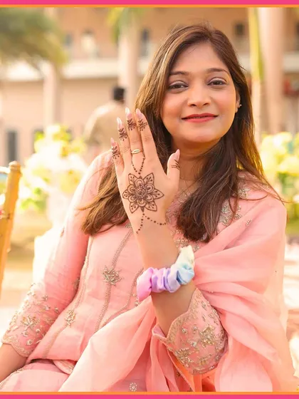 A happy guest showing off her beautiful Mehendi design. We believe in making every guest feel special.