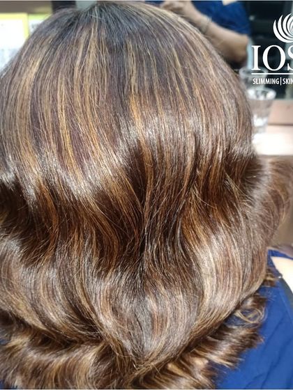 This is the beautiful result of expertly placed highlights. The blend of caramel and honey tones creates a warm, multi-dimensional look with incredible shine and depth, styled into soft, glamorous waves.
