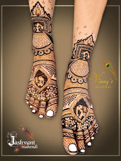 A detailed bridal feet design featuring elephant motifs within intricate frames. The pattern covers the entire foot for a complete bridal look.