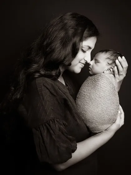 A timeless mother and child portrait, finished in a classic sepia tone to highlight the tender connection. These intimate shots are a beautiful part of any newborn session.