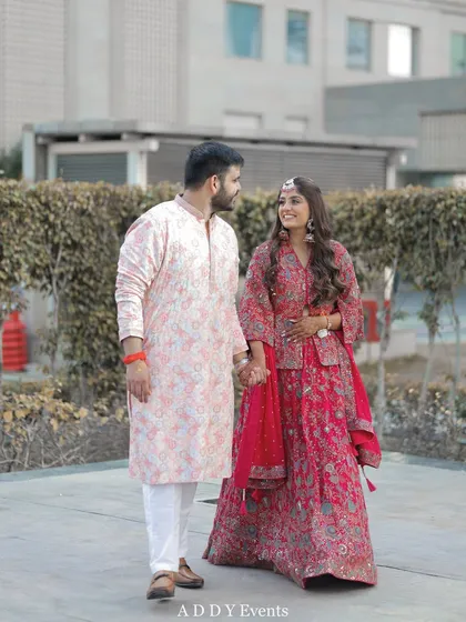 The couple walks hand-in-hand, sharing a look of love and happiness.