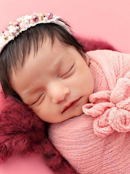 This angle showcases the beautiful floral headband that complements the pink theme perfectly.