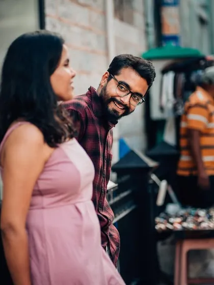 A candid, stolen glance between a couple on a bustling Bangalore street. This image represents our ability to find and freeze authentic, unposed moments of connection, even in the most everyday settings.