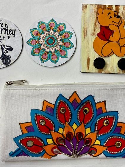 This is just a small sample of the wonderful things kids create in our camps. Here you can see a hand-painted pouch, custom coasters, and a wooden key holder.