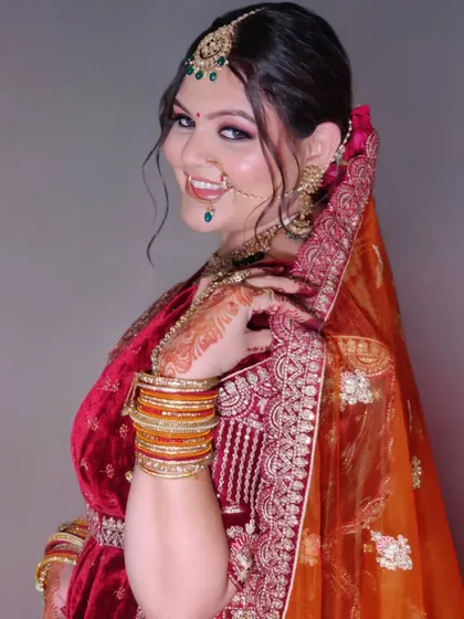 A classic bridal pose showing off the side profile, the elegant hair bun, and the perfectly draped dupatta.