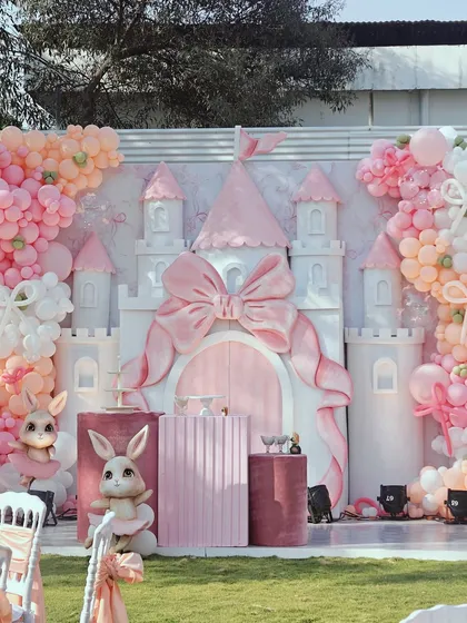 For a truly enchanting celebration, we designed this fairytale bunny and castle theme. The centerpiece is a custom-built castle with a large pink bow, surrounded by plush bunnies, elegant pedestals, and a soft pastel balloon arrangement, creating a magical photo opportunity for a first birthday or baby shower.