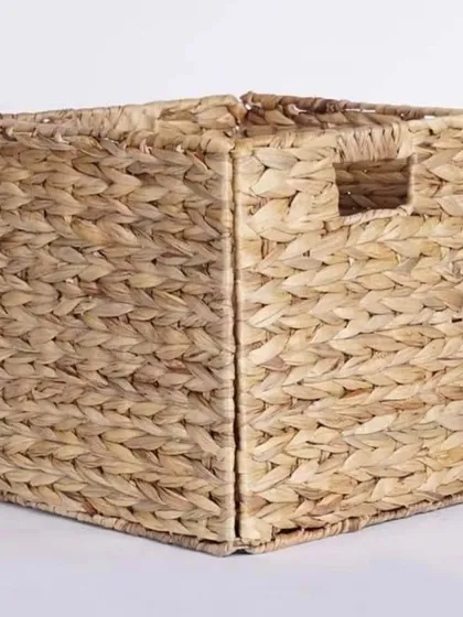 A square, foldable storage basket woven from water hyacinth. This eco-friendly basket is perfect for organizing shelves and closets, and its collapsible design makes it easy to store when not in use.