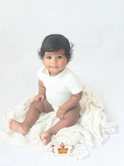 Look at those beautiful eyes. Sitter sessions are so special because your baby's personality is really starting to shine. My minimalist white backdrop ensures nothing distracts from their adorable expressions.