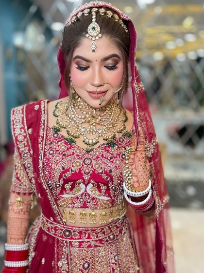A close-up of this bride's "glass skin" makeup. The focus is on a luminous, healthy glow, paired with a soft brown smoky eye and a traditional nath.