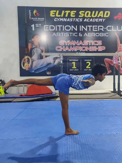 This young gymnast is demonstrating a perfect arabesque, a fundamental balance pose. We focus on correcting posture and alignment right from the beginner stages.