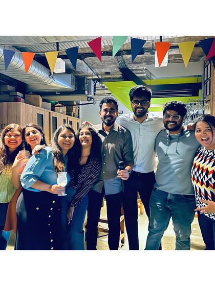 A group of friends celebrating a successful karaoke performance, smiles all around.