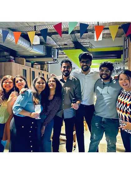 A group of friends celebrating a successful karaoke performance, smiles all around.